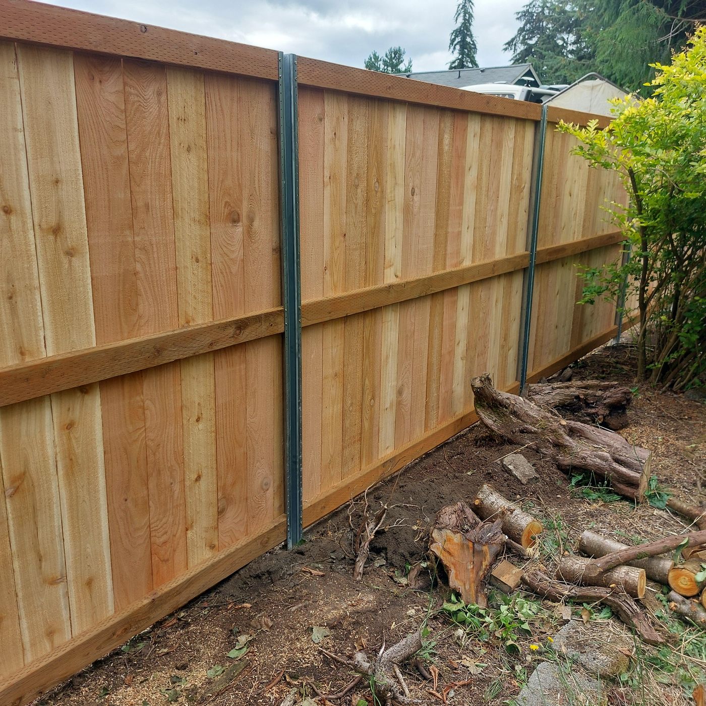 Wood privacy fence panel showing exposed PostMaster+ steel post in Baton Rouge, LA